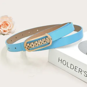 Women skinny blue leather belt with sparkling rhinestone gold buckle detail product view.