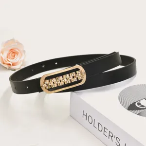Detailed shot of women's black slim belt with gold rhinestone geometric buckle, fashion accessory