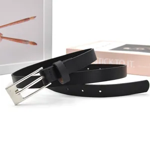 Black PU leather belt close-up, silver-colored metal buckle, detail view for women fashion.