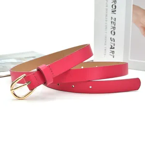 Close-up detail of hot pink women thin leather belt with gold buckle for stylish outfits.