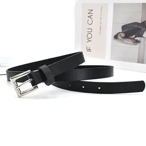 Detail view of a sleek black leather belt featuring a classic silver pin buckle for women.