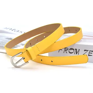 Women yellow thin leather belt with silver pin buckle, elegant daily fashion accessory.