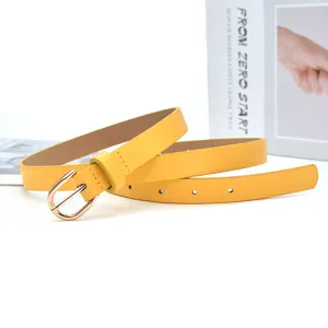 Detailed close-up of a stylish yellow slim leather belt with gold pin buckle accessory.