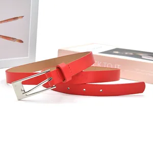 Red PU leather belt with silver pin buckle for women casual wear close up detail