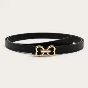 Closeup of stylish black leather belt with gold heart buckle, versatile accessory for jeans.