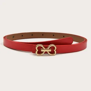 Close-up detail of a stylish red leather belt featuring a cute gold double heart buckle design.