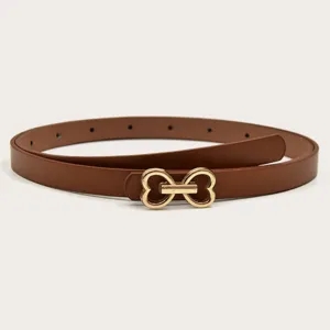 Detailed view of a brown thin leather belt featuring a chic gold heart buckle, versatile daily wear.