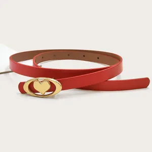 Red leather belt for women, slim strap with gold heart oval buckle for dress pants.