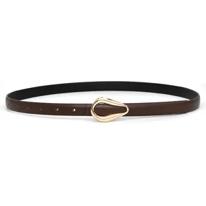 Detailed shot of women's brown PU leather thin belt with elegant gold horseshoe metal buckle.
