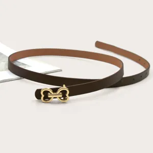 Slim brown leather belt with gold heart buckle, stylish and versatile for jeans and dresses.