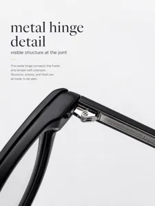 Detail view of black eyeglasses showing precision metal hinge and screw construction.