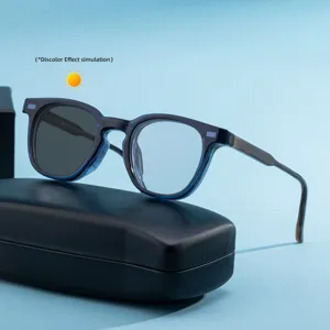 Trendy blue frame square photochromic sunglasses for men with a black case on background