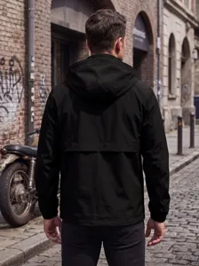 Men's black hooded jacket detail view, featuring durable waterproof fabric and windproof back flap.