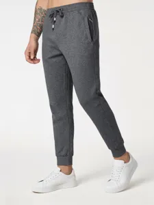 Men's gray casual joggers detailed view, featuring elastic drawstring waist and cuffed hems.