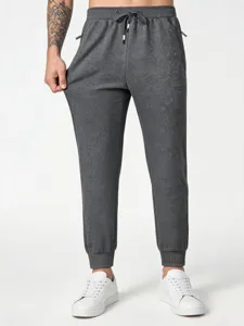 Men's casual sweatpants detailed view, dark grey jogger with elastic drawstring waist.