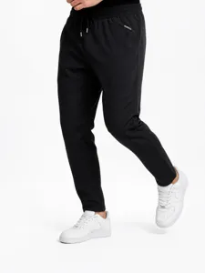 Detailed view of men's black sweatpants, casual jogger pants with elastic drawstring waist.