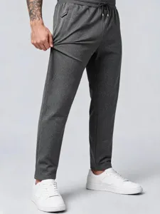 Men's dark grey casual athletic jogger pants detail shot, showing drawstring waist and fabric.