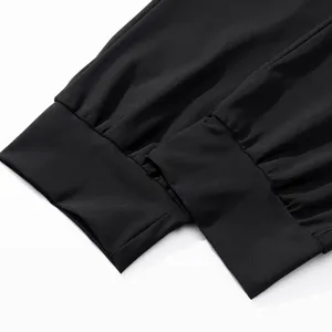 Close-up detail of black mens quick dry pants elastic cuffed hem for sports fitness activewear.