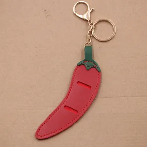 Red chili pepper leather keychain bag charm with gold hardware sunglasses clip accessory pendant.