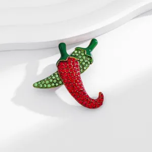 Close-up detail of sparkling rhinestone chili brooch, elegant fashion accessory jewelry.