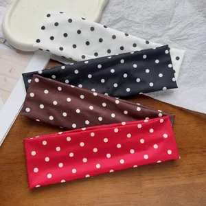 Detailed view of wide elastic polka dot headbands in various colors for sports and daily wear.