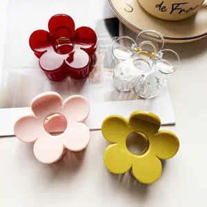 Detail view of four colorful acrylic flower hair claw clips, perfect for elegant daily styling.