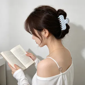 Blue white striped hair claw clip detail shot, elegant summer hair accessory style.