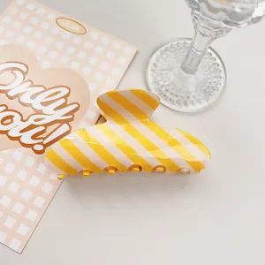 Summer yellow white striped PVC hair claw clip, stylish minimalist hair accessory for women.