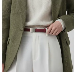 Minimalist leather belt detail shot showcasing frosted texture and sleek metal buckle design.