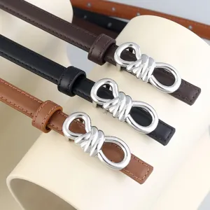 Thin leather belts with metallic knot buckles in brown, black and tan for women fashion.