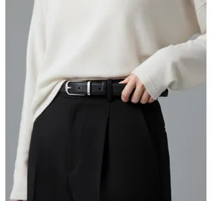 Black leather belt detail view featuring a classic silver metal buckle for women.