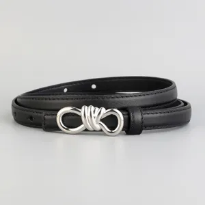 Detail view of black leather belt with silver tone knot buckle, minimalist style.