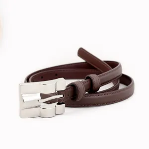 Women brown thin leather belt detail shot, elegant silver buckle fashion accessory.