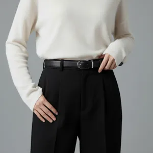 Minimalist black leather belt featuring a sleek silver buckle, close-up detail showcasing classic style.
