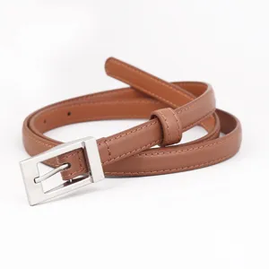 Close-up detail of the elegant brown thin leather belt with a polished silver square buckle.
