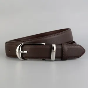 Close-up detail of women's vintage brown leather belt with stylish silver metal buckle for jeans.