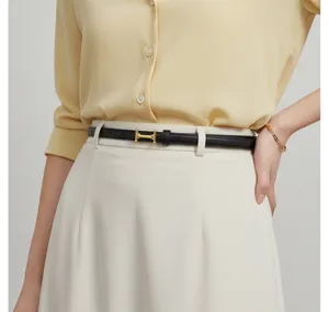 Elegant women's leather belt with gold metal buckle, stylish minimalist accessory.