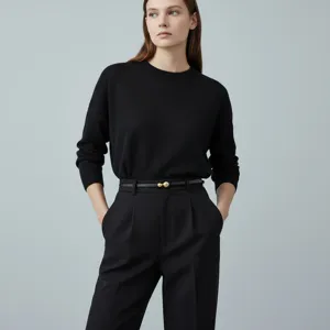 Detail view of minimalist women's leather belt featuring a unique golden sphere buckle.