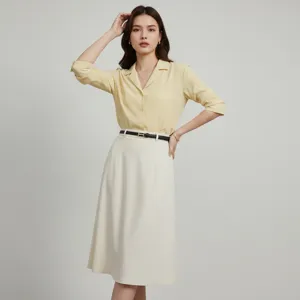 Detailed view of thin black leather belt with gold buckle worn by model in studio outfit.