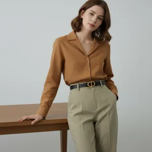 Black leather belt with gold-tone buckle, elegant minimalist waist accessory detail.