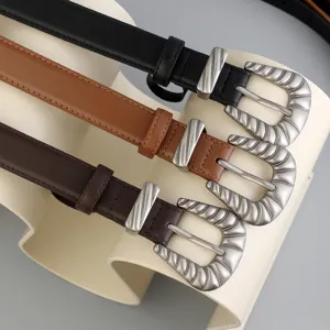 Detailed close-up of vintage western style metal belt buckles in three stylish colors.