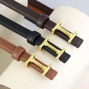 Close-up detail of thin leather women belts with metal H-shaped buckle in three classic colors.