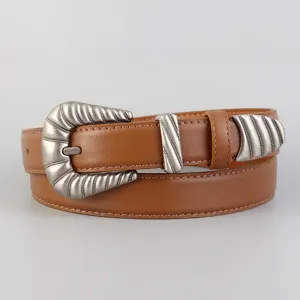 Detail shot of retro western style brown leather belt with ornate silver metal buckle.