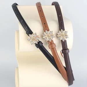 Womens thin leather belt featuring a sparkling rhinestone flower buckle, elegant accessory.