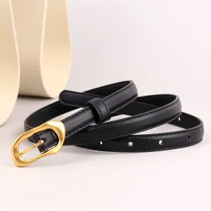Black leather belt close up featuring gold buckle and perforated design for women fashion.