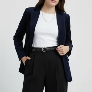 Detail view of women's leather belt, elegant black accessory styled with outfit.