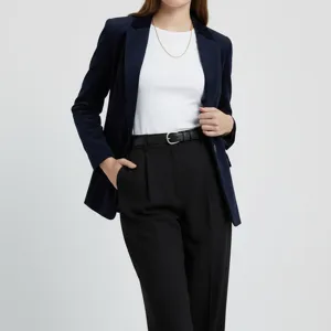 Close-up detail shot of a classic black leather belt worn with professional attire in studio.