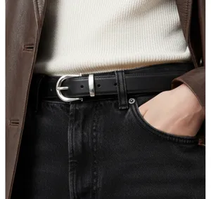Detail view of a classic black leather women belt featuring a sleek silver metal buckle styling.