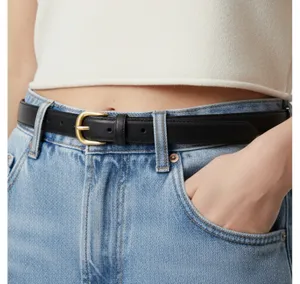 Minimalist black leather belt for women with gold buckle, perfect for casual jeans and daily wear.