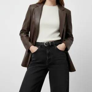 Close-up detail of women's genuine leather belt worn with black jeans and jacket stylish.